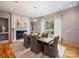 Inviting dining room featuring elegant lighting, fireplace and large window at 4400 Sharon View Rd, Charlotte, NC 28226