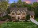 Charming Tudor-style home showcasing architectural details and manicured landscaping at 4400 Sharon View Rd, Charlotte, NC 28226
