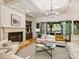 Bright living room with fireplace, built-ins and French doors to the patio at 4400 Sharon View Rd, Charlotte, NC 28226