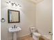 Charming powder room featuring decorative mirror, pedestal sink, and neutral paint color offering a quaint and comfortable space at 4400 Sharon View Rd, Charlotte, NC 28226