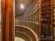 Unique wine cellar with custom wooden shelving and curved design at 4400 Sharon View Rd, Charlotte, NC 28226