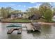 Waterfront property featuring a private dock with boat slips and nearby upscale homes at 477 Big Indian Loop, Mooresville, NC 28117
