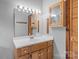 Bathroom featuring a vanity sink with a wooden cabinet and a large mirror at 477 Big Indian Loop, Mooresville, NC 28117