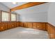 Carpeted bedroom featuring wooden wall paneling and large windows at 477 Big Indian Loop, Mooresville, NC 28117