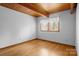 Bright bedroom featuring hardwood floors, neutral walls, wooden ceiling and a large window at 477 Big Indian Loop, Mooresville, NC 28117
