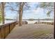 Large wooden deck overlooking the lake, surrounded by mature trees and peaceful scenery at 477 Big Indian Loop, Mooresville, NC 28117