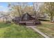 Attractive waterfront home featuring large windows, a deck, and a well-manicured lawn at 477 Big Indian Loop, Mooresville, NC 28117