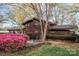Beautiful waterfront home with mature landscaping and flowering bushes at 477 Big Indian Loop, Mooresville, NC 28117