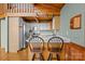 Cozy kitchen features wooden accents, stainless steel appliances, and breakfast bar with spindle-back chairs at 477 Big Indian Loop, Mooresville, NC 28117
