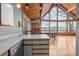 Kitchen bar overlooks a spacious dining and living area with lake views at 477 Big Indian Loop, Mooresville, NC 28117