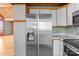 Spacious kitchen with stainless steel refrigerator opens to airy living space at 477 Big Indian Loop, Mooresville, NC 28117