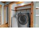 Dedicated laundry room with washer, dryer, and overhead storage shelves at 477 Big Indian Loop, Mooresville, NC 28117