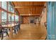 Open-concept living and dining area with wood ceilings, fireplace, and lake views at 477 Big Indian Loop, Mooresville, NC 28117