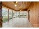 Bright sunroom featuring wood paneling, tile flooring, and lots of windows offering serene views at 477 Big Indian Loop, Mooresville, NC 28117