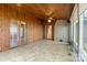 Spacious sunroom boasts wood paneling, tile flooring, and large windows for natural light at 477 Big Indian Loop, Mooresville, NC 28117