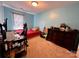 Bedroom with window, red bed, desk, dark dresser and wood-look floors at 4927 Curtiswood Dr, Charlotte, NC 28213