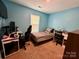 Bedroom with natural light, desk, chair, and computer setup at 4927 Curtiswood Dr, Charlotte, NC 28213