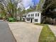 Exterior view of a two-story home with a large concrete driveway and lawn at 4927 Curtiswood Dr, Charlotte, NC 28213