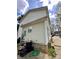 Exterior shot of home's side with vinyl siding, a concrete foundation, and exterior utilities visible at 4927 Curtiswood Dr, Charlotte, NC 28213