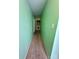 View of a hallway leading to a laundry area with a washer and dryer, green walls and beige carpet at 4927 Curtiswood Dr, Charlotte, NC 28213