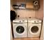 Washer and dryer in laundry room with wire shelf for storage at 4927 Curtiswood Dr, Charlotte, NC 28213