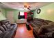 Comfortable living room featuring hardwood floors and a flat screen television at 4927 Curtiswood Dr, Charlotte, NC 28213