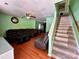 A living room that flows into the kitchen with hardwood floors and staircase at 4927 Curtiswood Dr, Charlotte, NC 28213