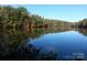 Scenic view of the lake and surrounding trees with calm water at 4989 Samoa Ridge Dr, Lancaster, SC 29720