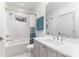 Bright bathroom featuring a shower-tub combo, neutral vanity, and modern fixtures with a window for natural light at 510 Poindexter Dr, Charlotte, NC 28209