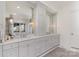 Elegant bathroom with double vanities, large mirrors, and ample storage at 510 Poindexter Dr, Charlotte, NC 28209