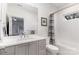 Well-lit bathroom with a gray vanity, a bathtub-shower combo and a large mirror to complete the space at 510 Poindexter Dr, Charlotte, NC 28209