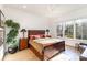 Bright bedroom with large windows, hardwood floors, and a comfortable bed with storage drawers at 510 Poindexter Dr, Charlotte, NC 28209