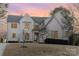 Elegant home with a manicured lawn and professionally landscaped front yard at twilight at 510 Poindexter Dr, Charlotte, NC 28209