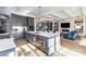 Open kitchen with island, stainless appliances, and a view of the living room and staircase at 510 Poindexter Dr, Charlotte, NC 28209