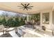 Inviting covered patio with outdoor seating, ceiling fan, and lush greenery, perfect for relaxation or entertaining guests at 510 Poindexter Dr, Charlotte, NC 28209
