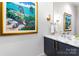Stylish powder room featuring a marble countertop, modern fixtures, and beautiful artwork at 510 Poindexter Dr, Charlotte, NC 28209