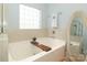 Bright bathroom features a soaking tub, a decorative ledge, and a wooden bath caddy at 5121 Alysheba Dr, Indian Trail, NC 28079