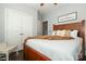 Comfortable bedroom features a ceiling fan, a door to the hallway, and a dark wooden bed frame at 5121 Alysheba Dr, Indian Trail, NC 28079