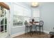 Cozy breakfast nook with table, chairs, and lots of natural light from the windows at 5121 Alysheba Dr, Indian Trail, NC 28079