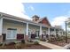 Beautiful clubhouse with covered patio and lush landscaping offers a great community gathering space at 5121 Alysheba Dr, Indian Trail, NC 28079