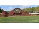 Bonterra community entrance sign with brick wall, horse sculpture, and manicured lawn under a blue sky at 5121 Alysheba Dr, Indian Trail, NC 28079
