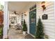 Inviting front porch with seating, decorative wreath, and charming exterior details at 5121 Alysheba Dr, Indian Trail, NC 28079