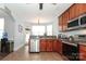 Well-lit kitchen features stainless steel appliances, tile flooring, and dark wood cabinetry at 5121 Alysheba Dr, Indian Trail, NC 28079