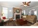 Comfortable living room with a brick fireplace and large windows for natural light at 5121 Alysheba Dr, Indian Trail, NC 28079