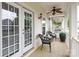 Inviting porch with comfortable seating, ceiling fan, and charming outdoor decor at 5121 Alysheba Dr, Indian Trail, NC 28079
