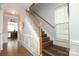 Elegant staircase with wood treads and white banister, leading to the upper level at 5121 Alysheba Dr, Indian Trail, NC 28079