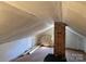 Attic with exposed brick chimney, angled ceilings and white walls at 526 Arlington Ave, Albemarle, NC 28001