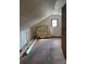 Attic featuring white walls and ceilings, and a brick chimney at 526 Arlington Ave, Albemarle, NC 28001