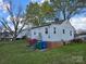 Quaint backyard view featuring a well-maintained lawn and the home's exterior at 526 Arlington Ave, Albemarle, NC 28001