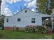 Exterior shot of home showing blue siding, brick foundation, and well-kept backyard at 526 Arlington Ave, Albemarle, NC 28001